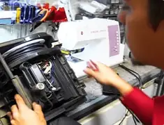 Vacuum repair technician servicing internal components on a workbench in Denver, CO